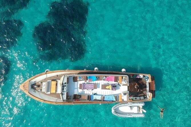 Tour of Ischia Island with Motor Yacht Rocca Corsa - Baia di San Montano: seafood lunch, drinks, and the best kind of onboard energy